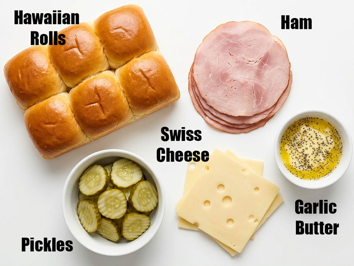 Ingredients for recipe on white background- Hawaiian rolls, cheese slices, ham slices, garlic butter, pickles.