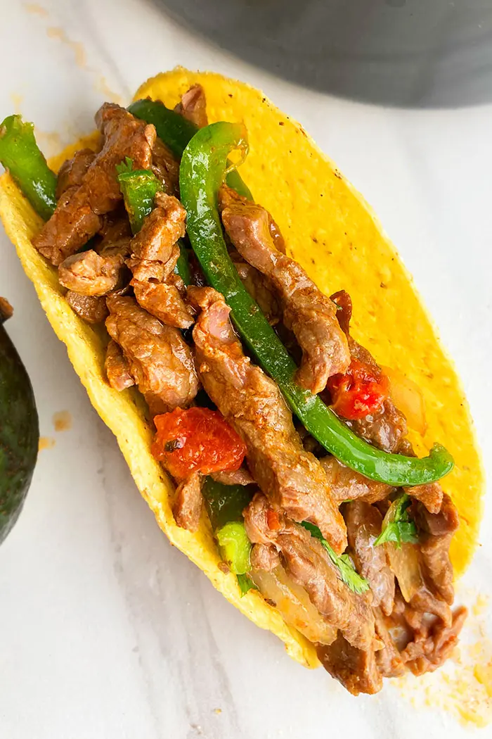 Overhead Shot of Mexican Steak Tacos in Hard Taco Shell on White Background