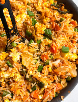 Easy Homemade Kimchi Fried Rice in Black Nonstick Pan With Black Spoon