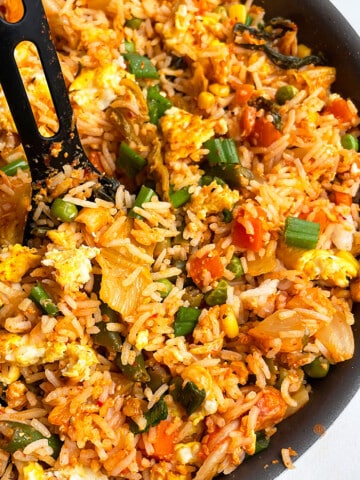 Easy Homemade Kimchi Fried Rice in Black Nonstick Pan With Black Spoon