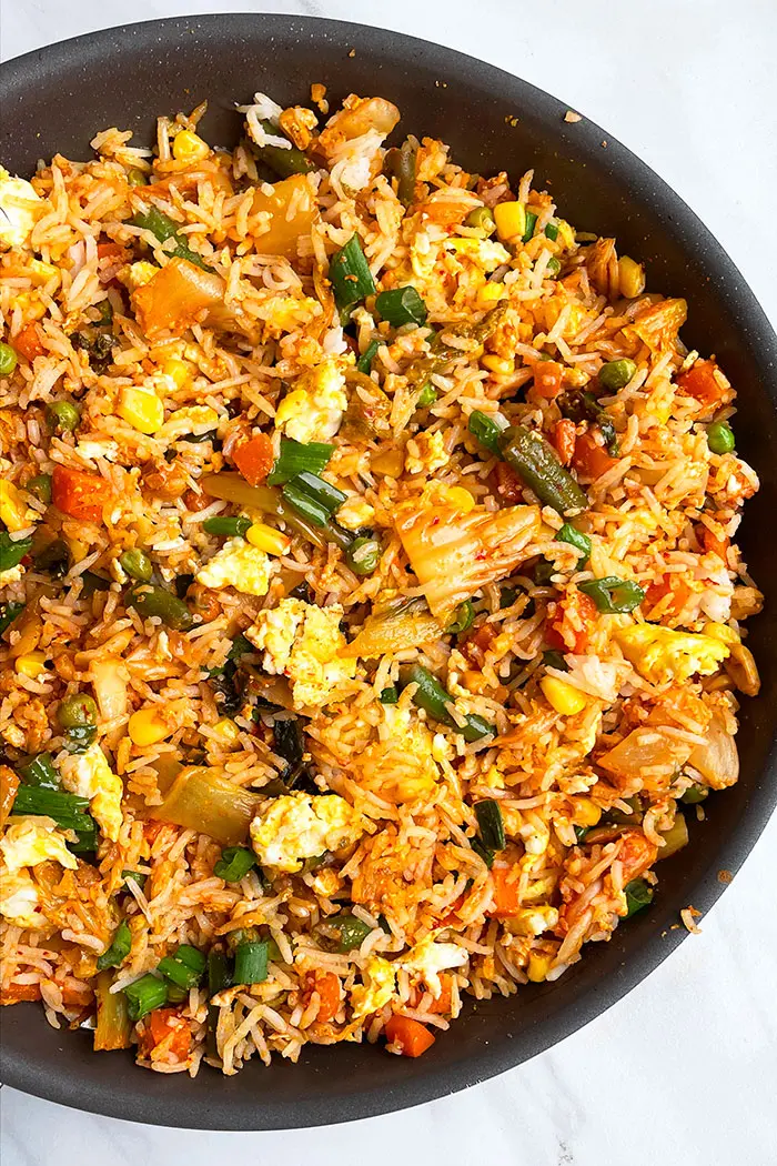 Korean Fried Rice in Black Nonstick Pot on White Background- Overhead Shot