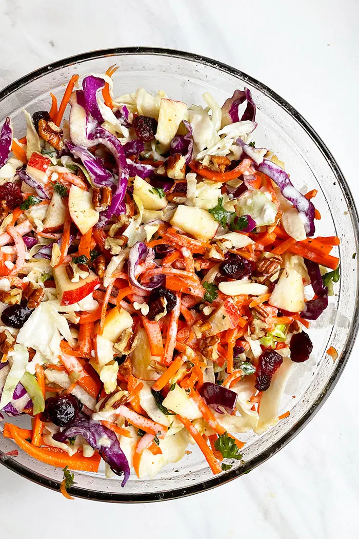 Overhead Shot of Apple Cabbage Slaw in Glass Bowl on White Background