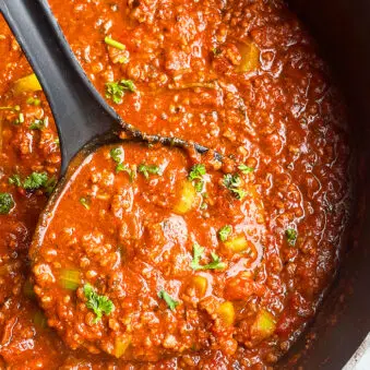 Easy Homemade Instant Pot Bolognese Sauce in Black Pot on White Background