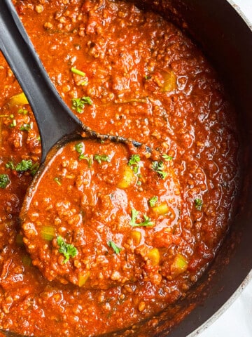 Easy Homemade Instant Pot Bolognese Sauce in Black Pot on White Background