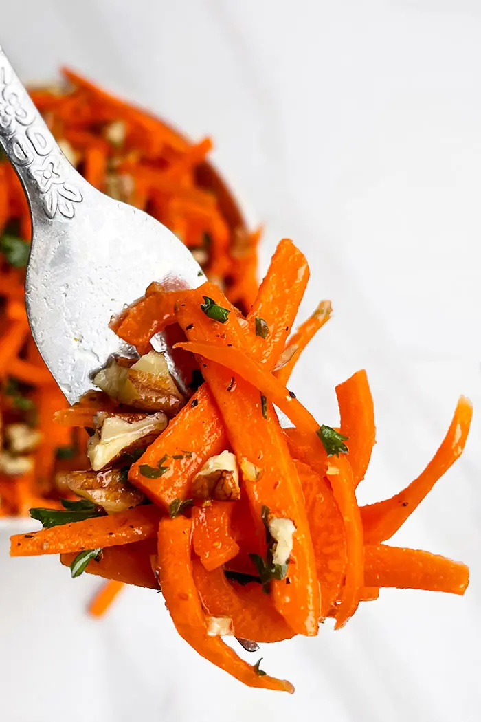 Fork Full of Carrot Coleslaw on White Background- Closeup Shot