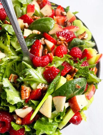 Best Summer Salad in Black Plate on White Background