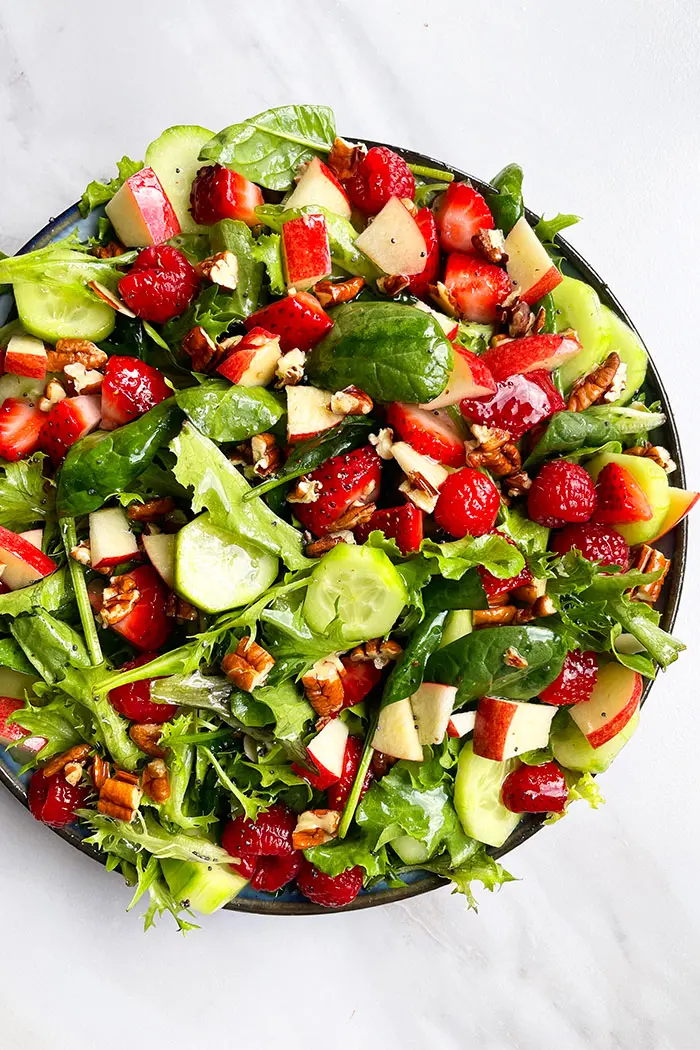 Best Summer Salad in Black Plate on White Background