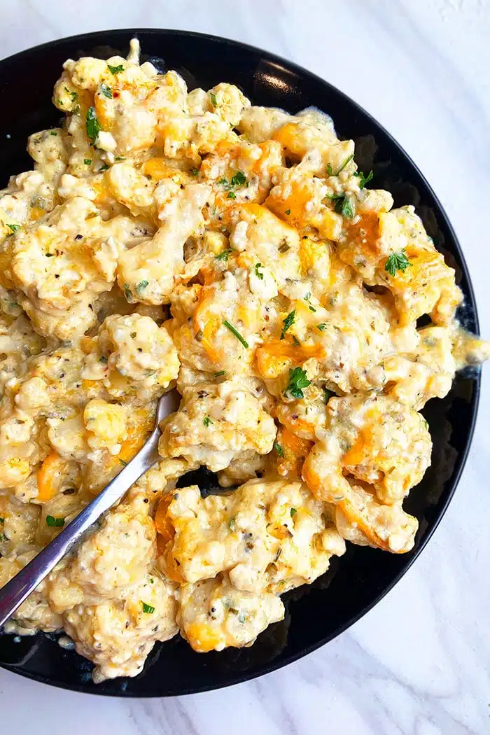 Easy Instant Pot Cheesy Cauliflower Served in Black Plate