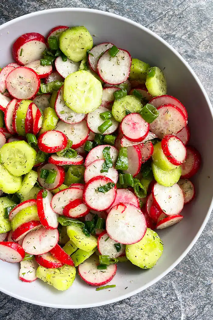 Easy Cucumber Radish Salad in Gray Bowl on Rustic Gray Background