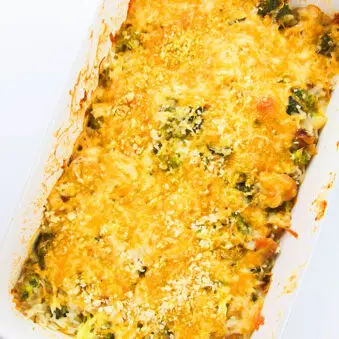 Easy Chicken Broccoli Rice Casserole in White Dish on White Background- Overhead Shot