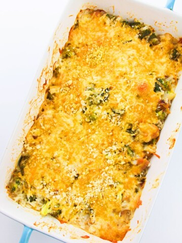 Easy Chicken Broccoli Rice Casserole in White Dish on White Background- Overhead Shot