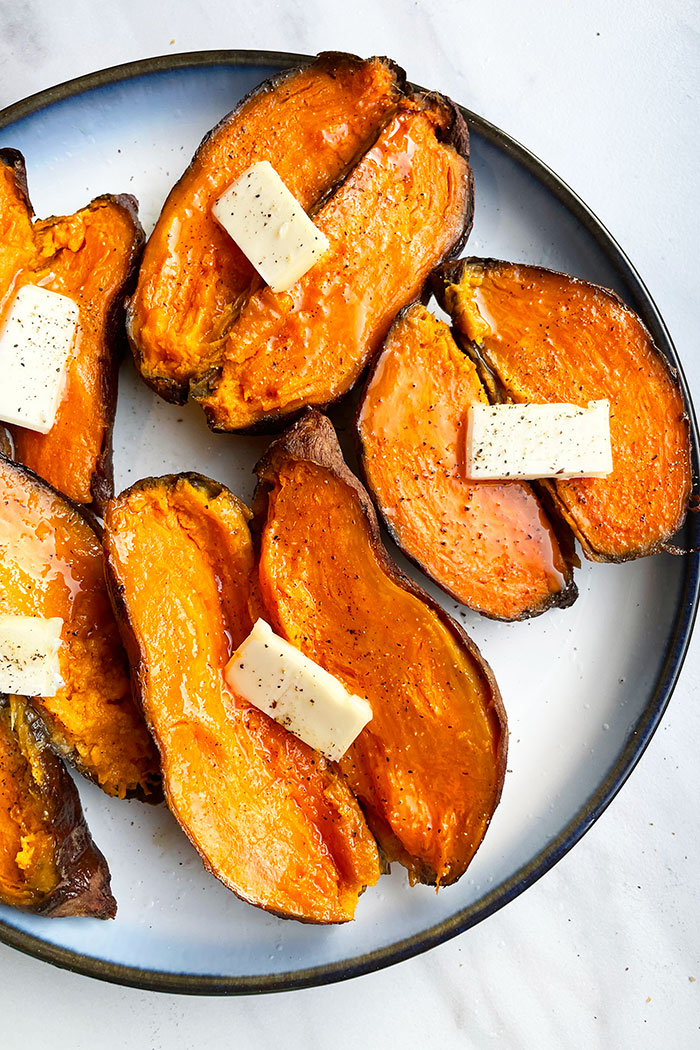 Easy Baked Sweet Potatoes Served in White Dish on White Background