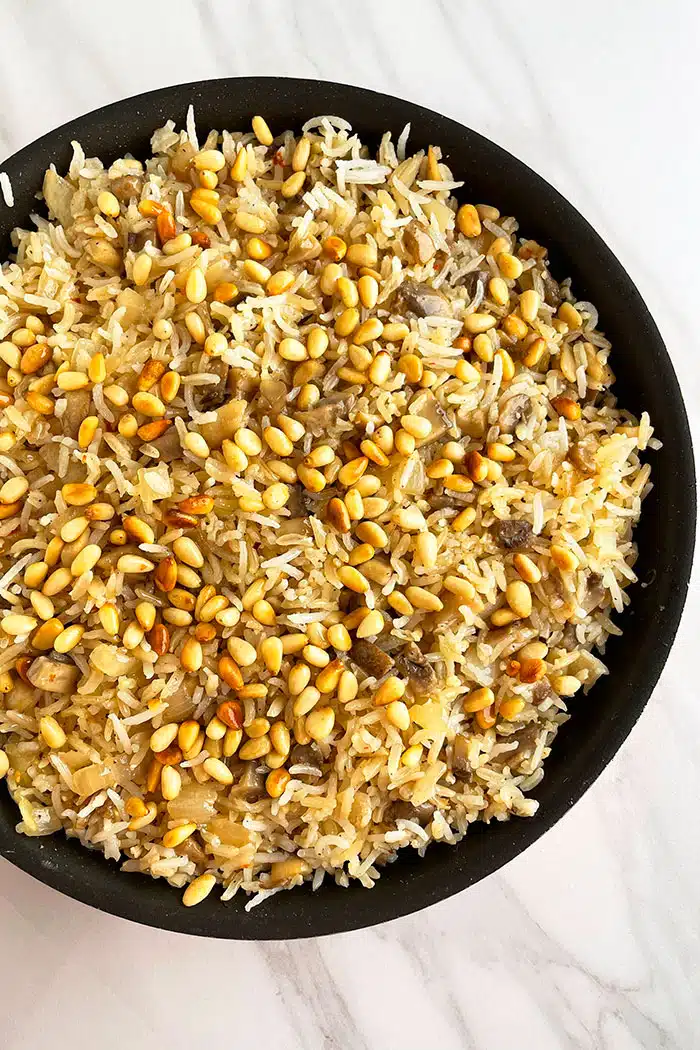 Easy Mushroom Rice in Black Pot on White Background