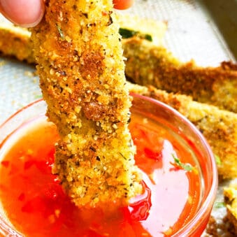 Easy Homemade Crispy Zucchini Fries (Courgette Fries) Being Dipped in a Bowl of Sweet and Spicy Sauce
