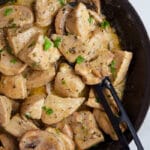 Easy Instant Pot Cream of Mushroom Chicken in Black Dish With Black Spoon on White Background