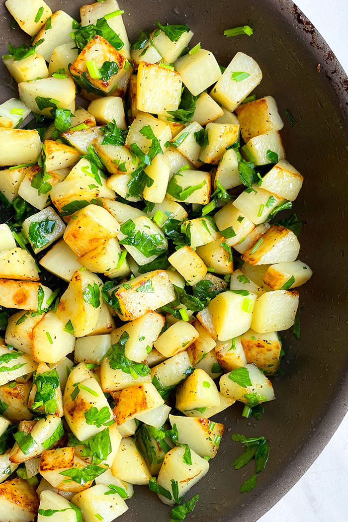 Easy Lemon Garlic Parsley Potatoes in Black Pan Made on Stovetop- Overhead Shot