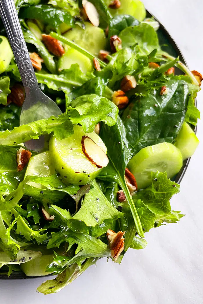 Fork Full of Simple Mixed Salad With Almonds and Pecans 