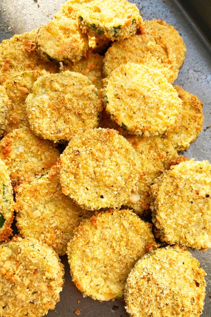 Baking Tray Filled With Crispy Courgette Chips.