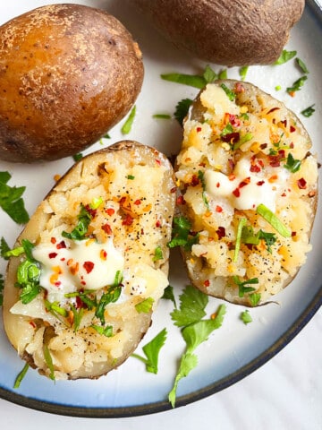 Easy Fluffy Microwave Baked Potatoes With Lots of Toppings in White Plate