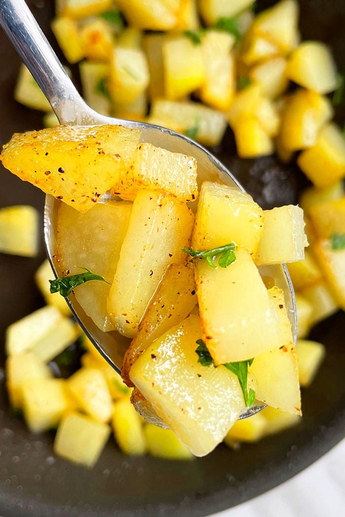 Spoonful of Crispy Garlic Lemon Pepper Potatoes- Closeup Shot