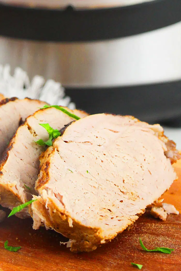 Pressure Cooker Boneless Pork on Brown Board- Closeup Shot of One Slice