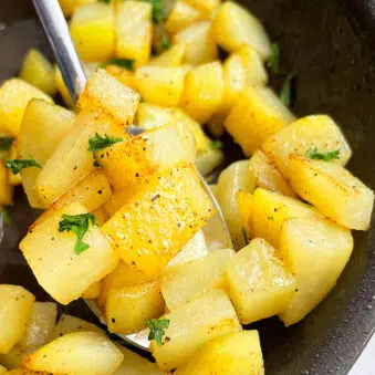 Easy Stovetop Crispy Sauteed Potatoes With Garlic and Lemon Pepper in Black Nonstick Pan