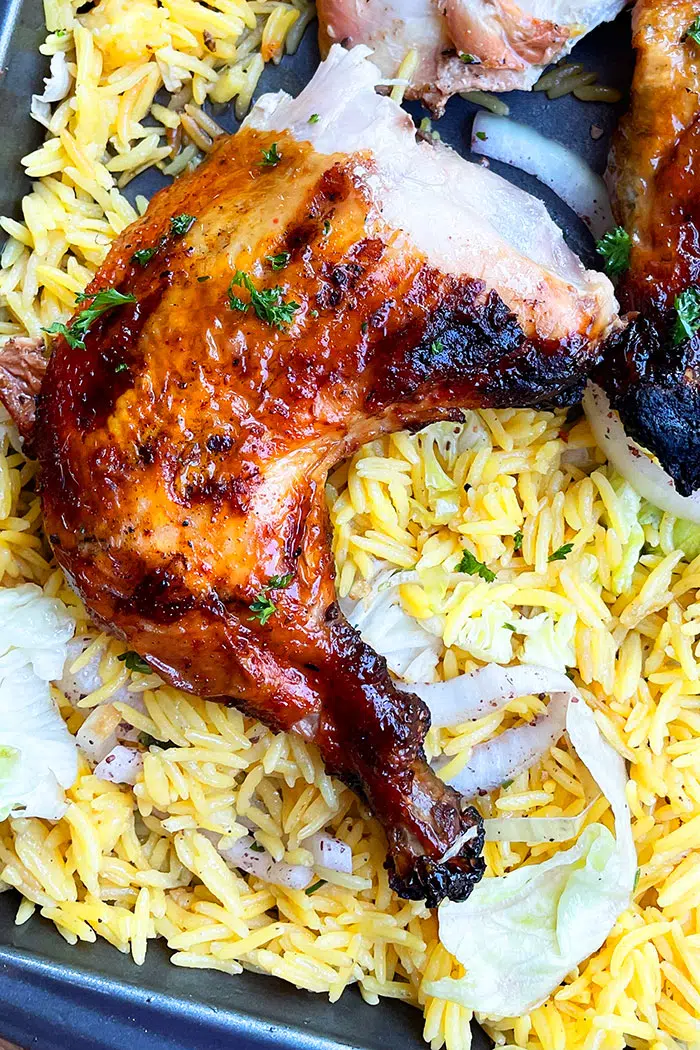 Closeup Shot of Baked Chicken Quarter on a Bed of Rice