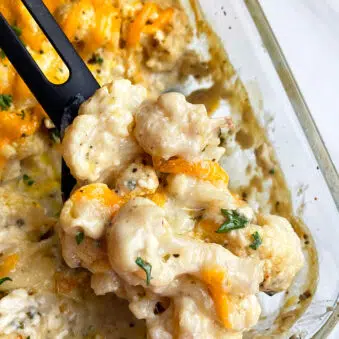 Easy Cheesy Creamy Cauliflower Casserole in Glass Dish- Closeup Shot