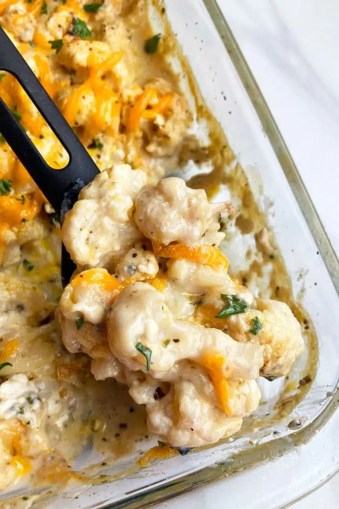 Creamy Cauliflower Casserole in Glass Dish on White Background