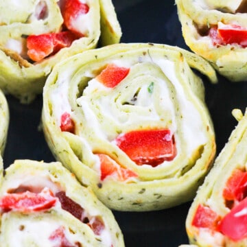 Closeup Shot of Pinwheel Sandwiches (Roll ups) Stuffed With Ranch Cream Cheese and Peppers.
