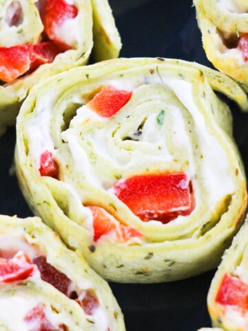 Closeup Shot of Pinwheel Sandwiches (Roll ups) Stuffed With Ranch Cream Cheese and Peppers.