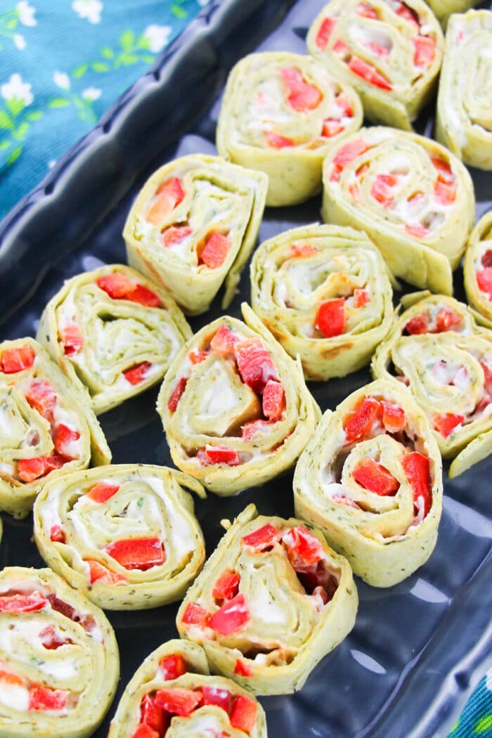 Black Dish Full of Roll Ups Appetizer. 
