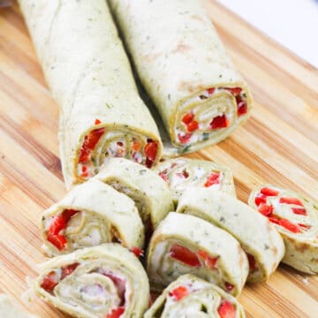 Sliced tortillas with filling on cutting board. 