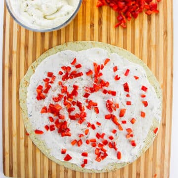 Chopped red peppers sprinkled on top of the ranch cheese. 