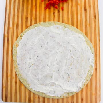 Ranch cream cheese spread evenly on top of tortilla. 