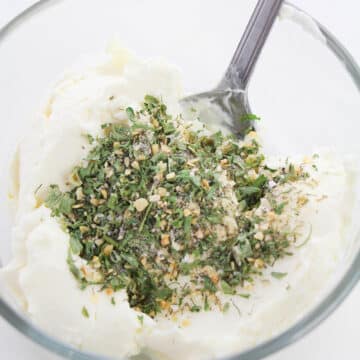 Glass bowl with cream cheese and dry ranch seasoning. 