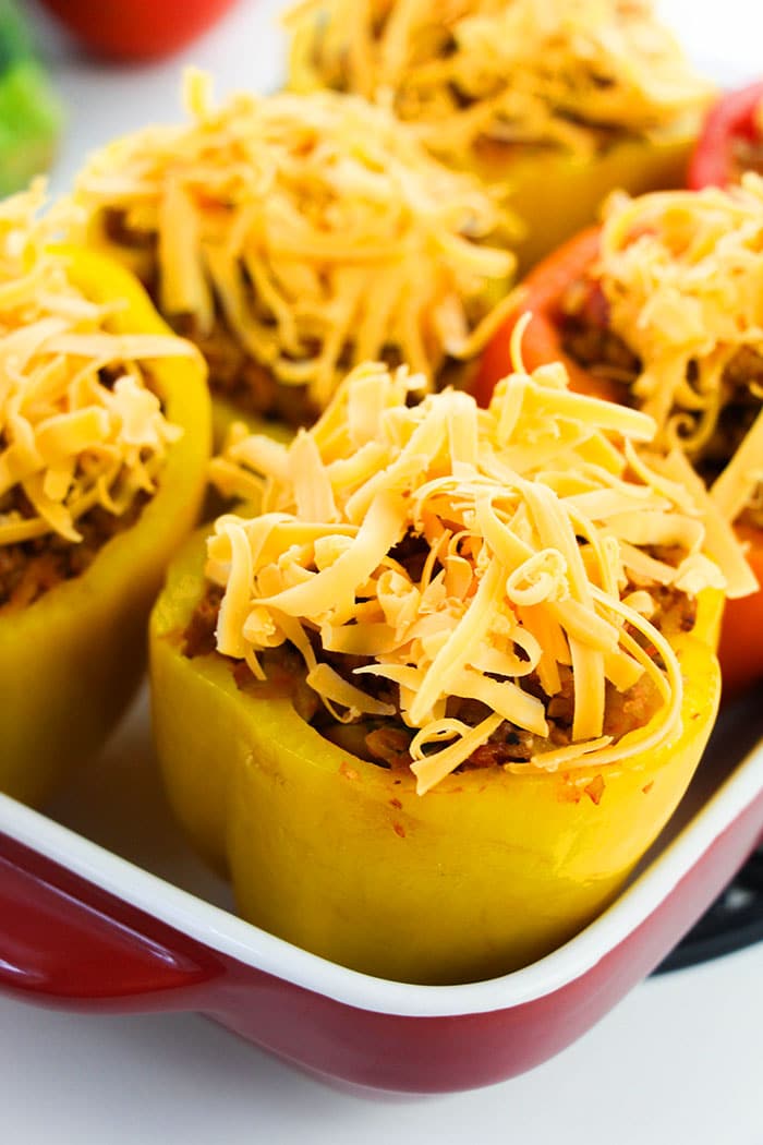 Best Homemade Stuffed Green Peppers With Shredded Cheese in White and Red Dish
