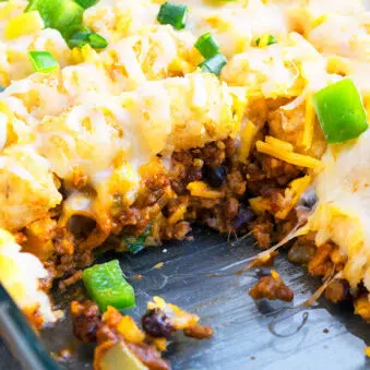 Easy Mexican Tater Tot Casserole With Ground Beef in Glass Dish- Closeup Shot