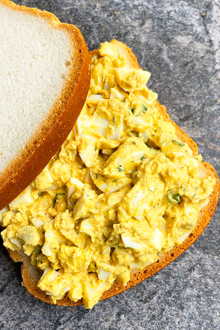 Best Sandwich With Creamy Egg Salad on Rustic Gray Background- Overhead Shot