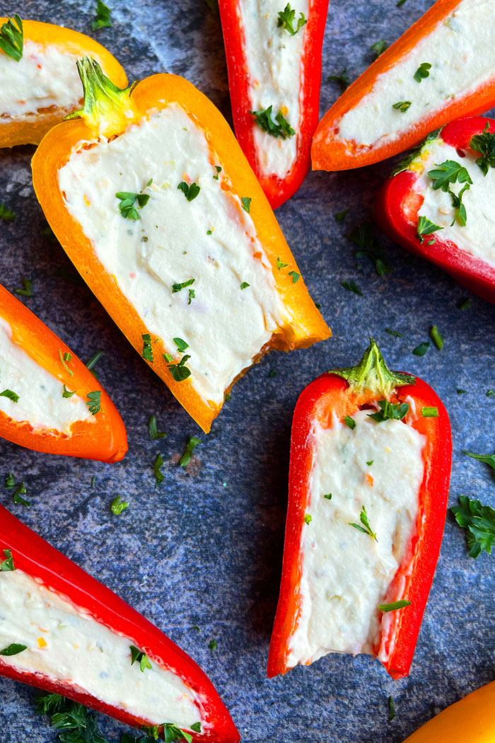 Partially Eaten Stuffed Mini Bell Peppers on Rustic Gray Background