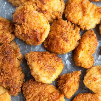 Easy Crispy Homemade Fried Chicken Bites on Paper- Overhead Shot