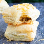 Stack of Ground Beef Puff Pastry (meat puffs or hand pies) on Rustic Gray Background.
