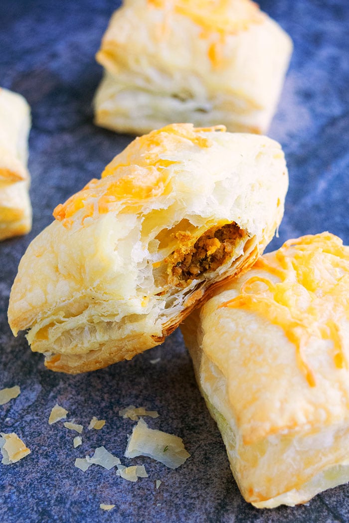 Partially Eaten Mexican Meat Puff Pastry or Puffs on Rustic Gray Background