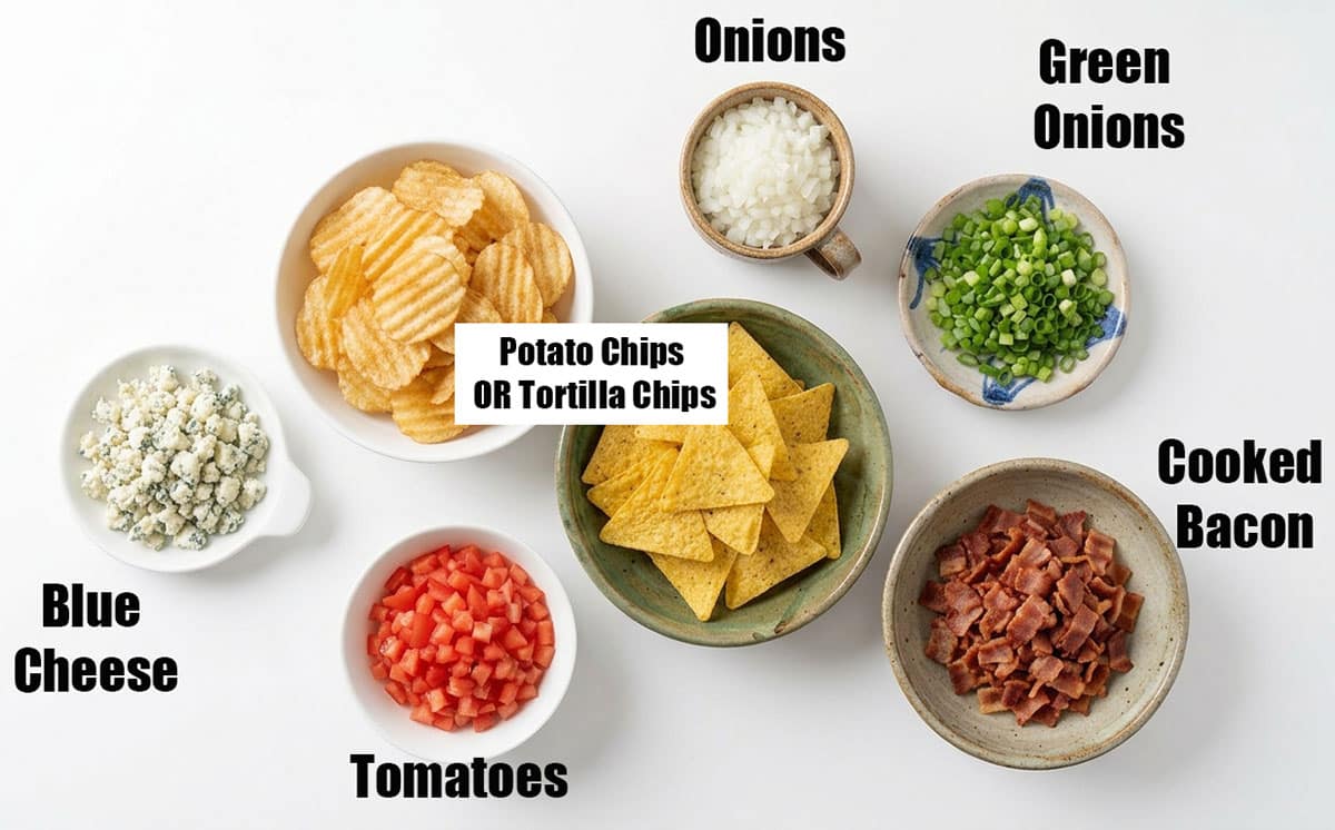 Ingredients for recipe on white background- chips, onions, green onions, tomatoes, bacon, cheese. 