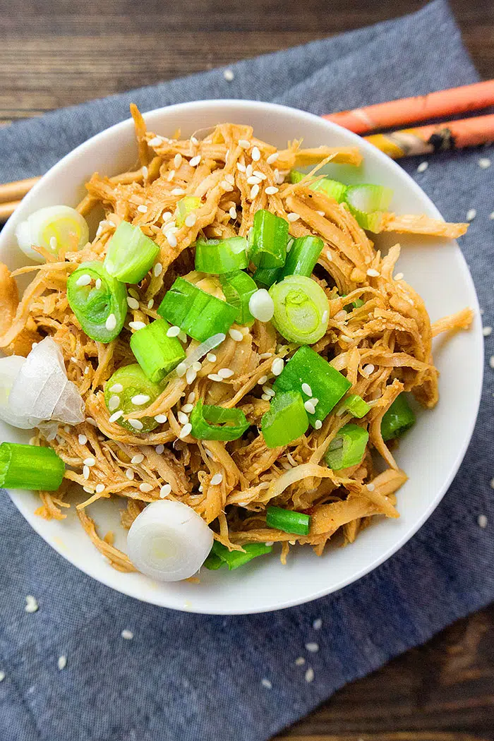 Easy Instant Pot Chinese Chicken Shredded in White Bowl Over Blue Napkin