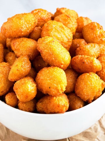 Easy One Pot Crispy Breaded Deep Fried Cheese Curds in White Bowl.