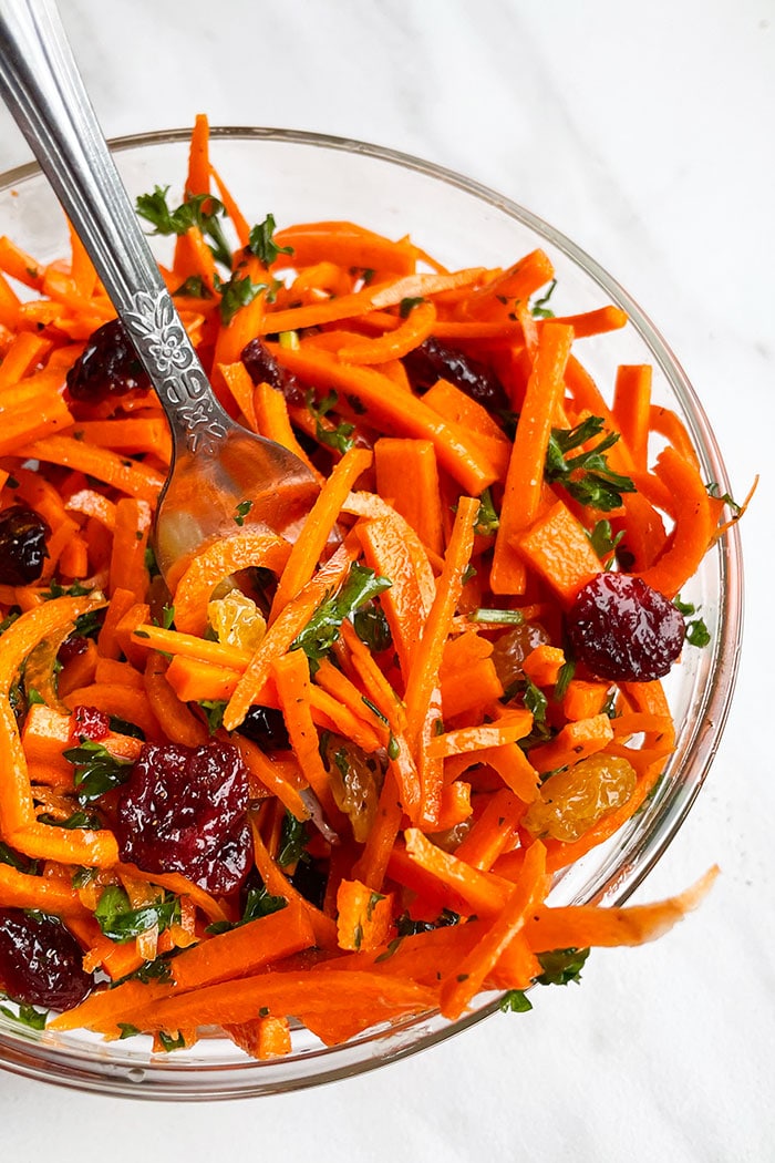 French Salad With Carrots, Raisins, Parsley in Glass Bowl