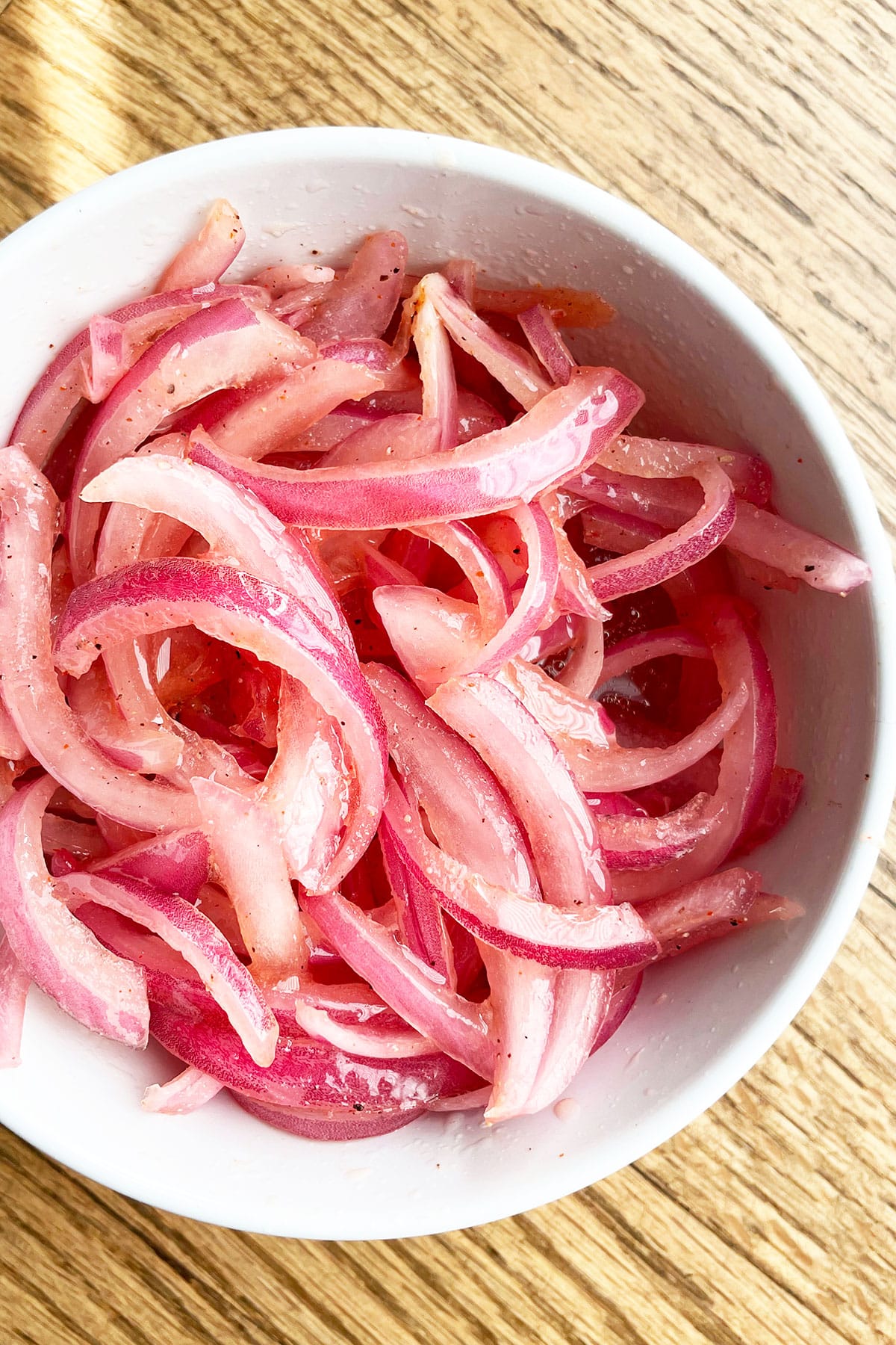 Easy Homemade Pickled Red Onions in White Bowl- Overhead Shot.