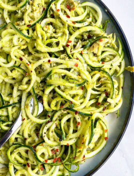 Zucchini Noodles With Pesto Sauce on White Dish With Black Rim