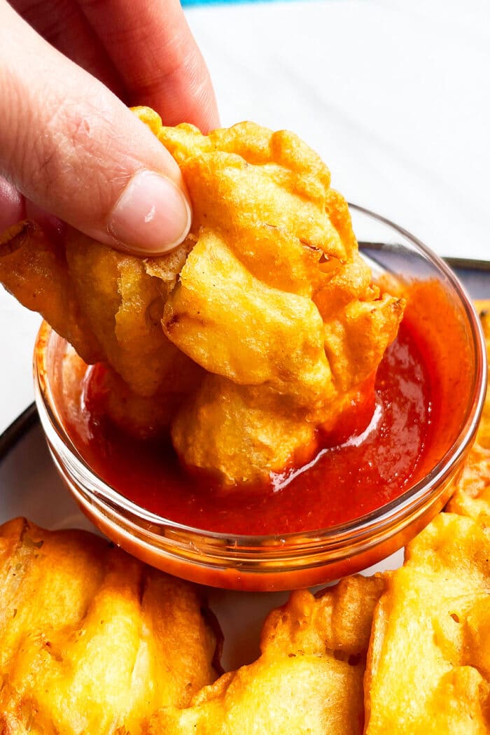 Homemade Indian Onion Pakora Dipped in Red Sauce- Closeup Shot.